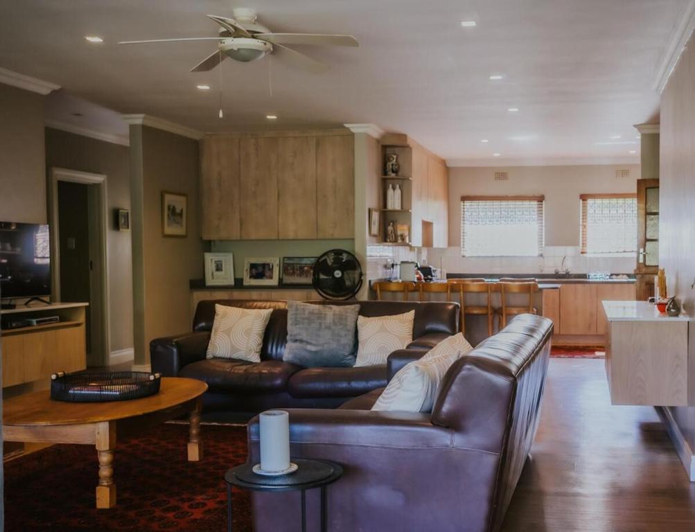 a living room with a couch and a table at Breede340 - Living the Breede in Malgas