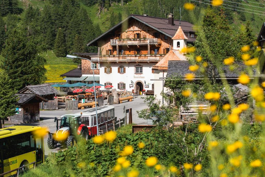 a large building in the middle of a village at Matreier Tauernhaus in Matrei in Osttirol