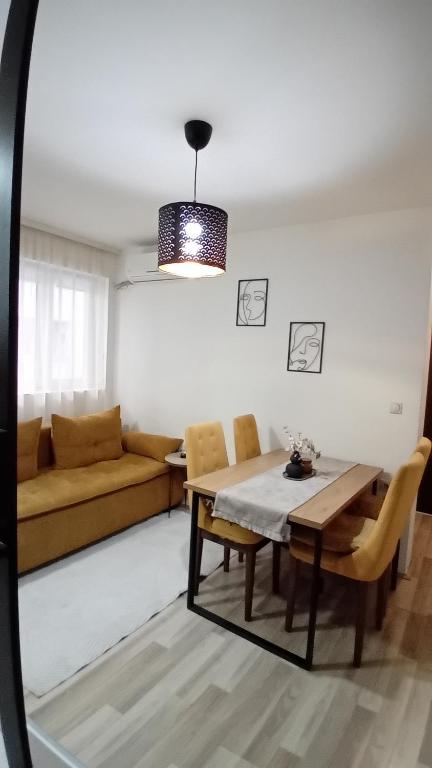 a living room with a table and a couch at Apartman,, Nina ,, in Jagodina