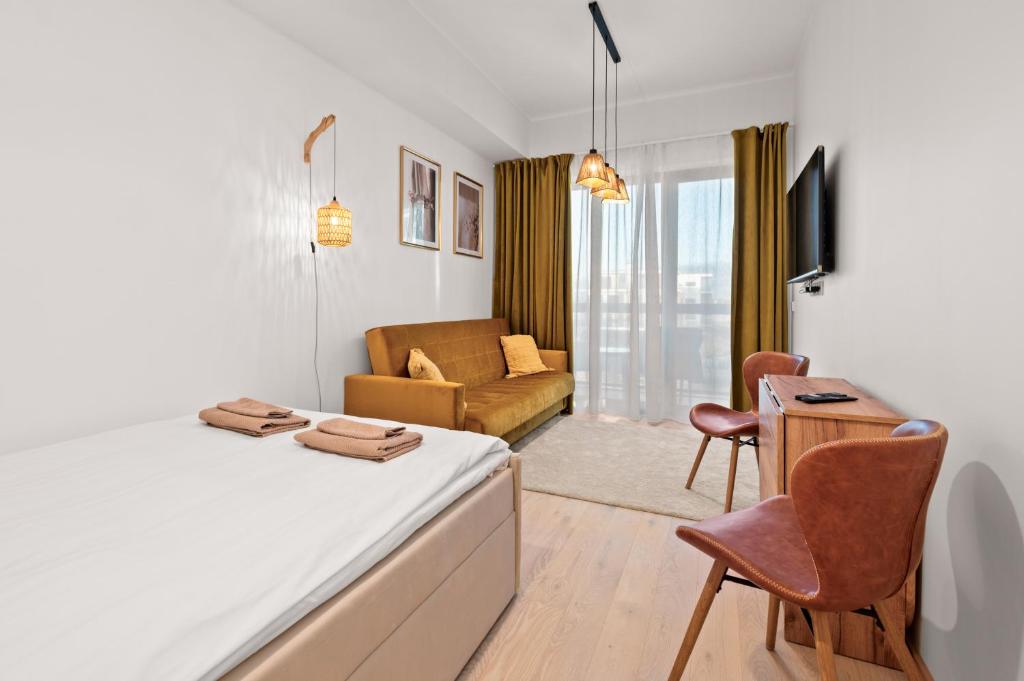 a bedroom with a bed and a living room at Marienholm Seaside Studio in Haapsalu