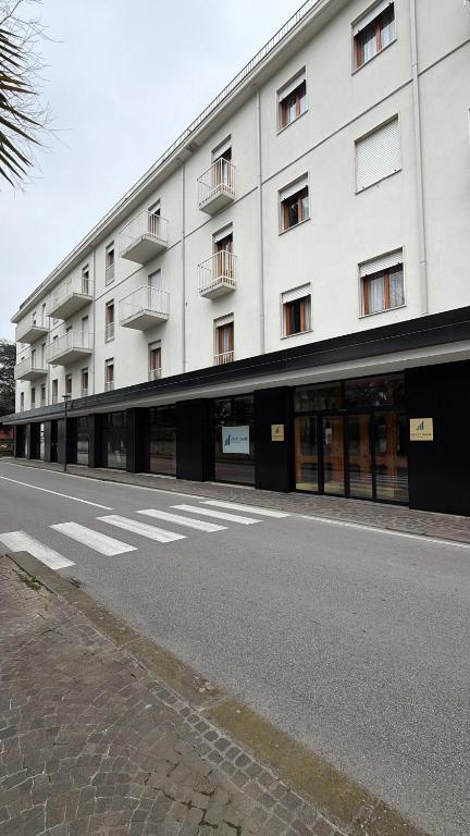 an empty street in front of a large building at UNITY BANK HOTEL Termale Padova RC12 in Abano Terme