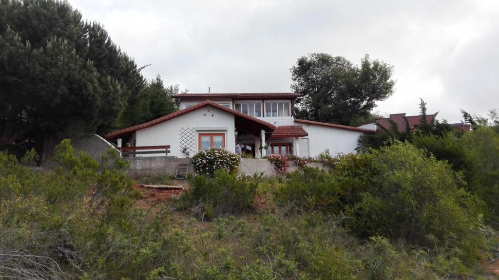 a white house on top of a hill at Casa Algarrobo Chile in Algarrobo