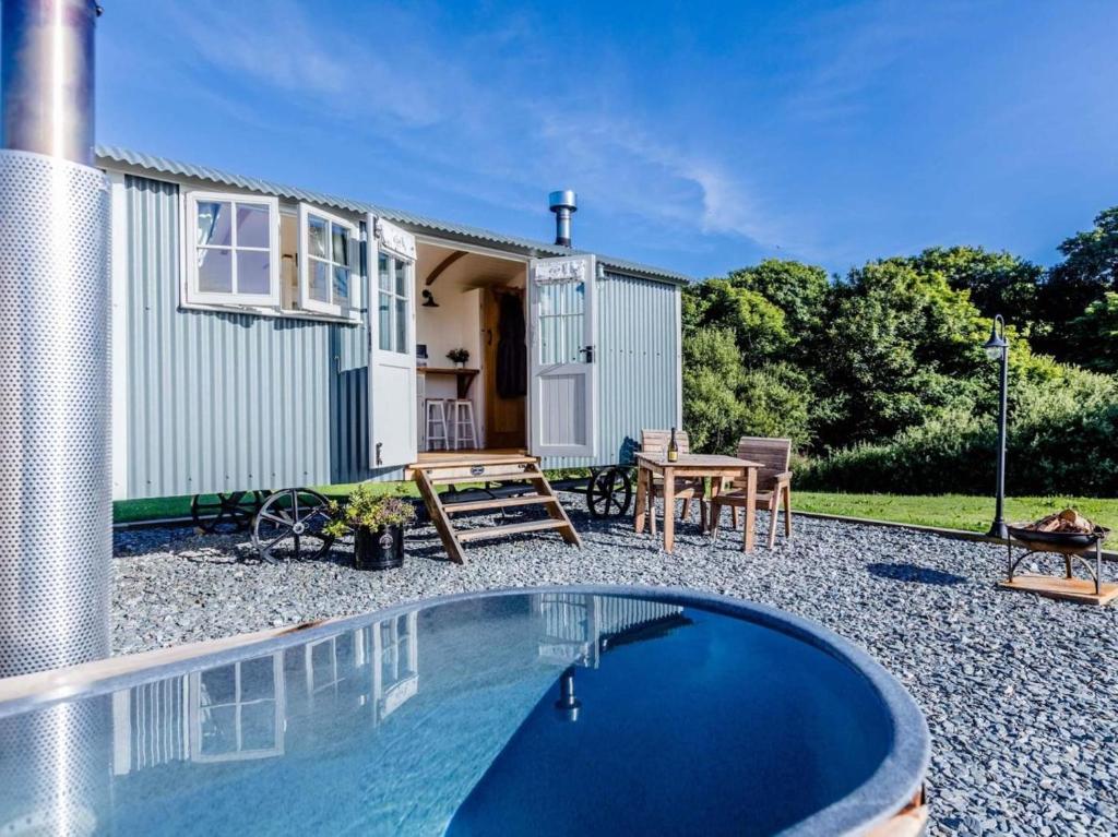 a holiday house with a swimming pool in front of it at 1 Bed in Boscastle oc-84015 in Boscastle