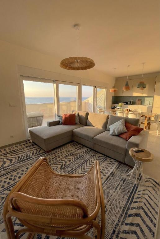 a living room with a couch and a table at Penthouse SKY DELUXE in Novalja