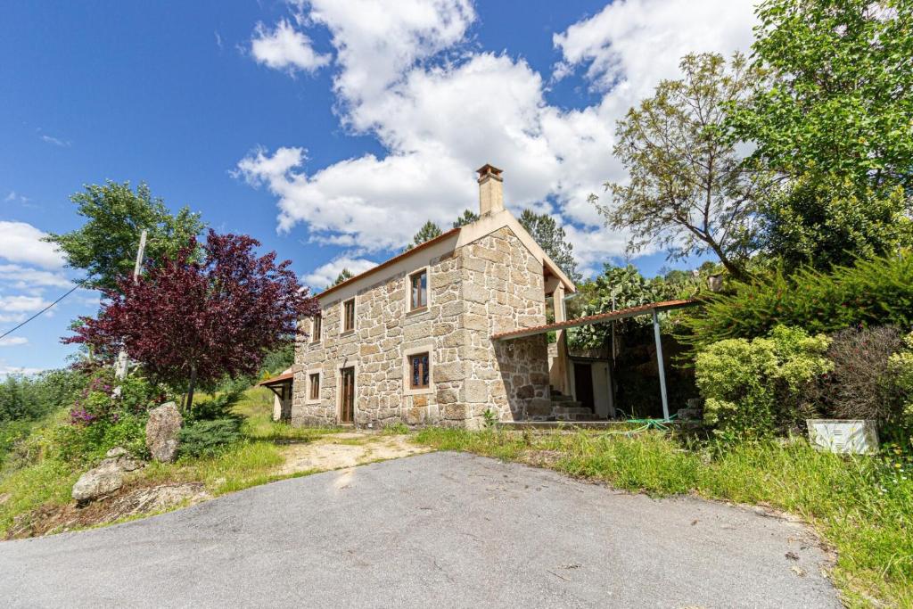 an old stone house on the side of a road at Guest H4U - Nature & Pool Guarda in Seixo Amarelo