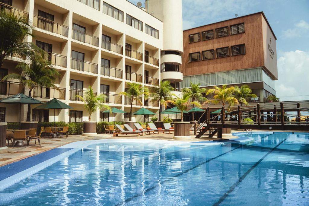 an image of a hotel with a swimming pool at Afago Mareiro Hotel in Fortaleza