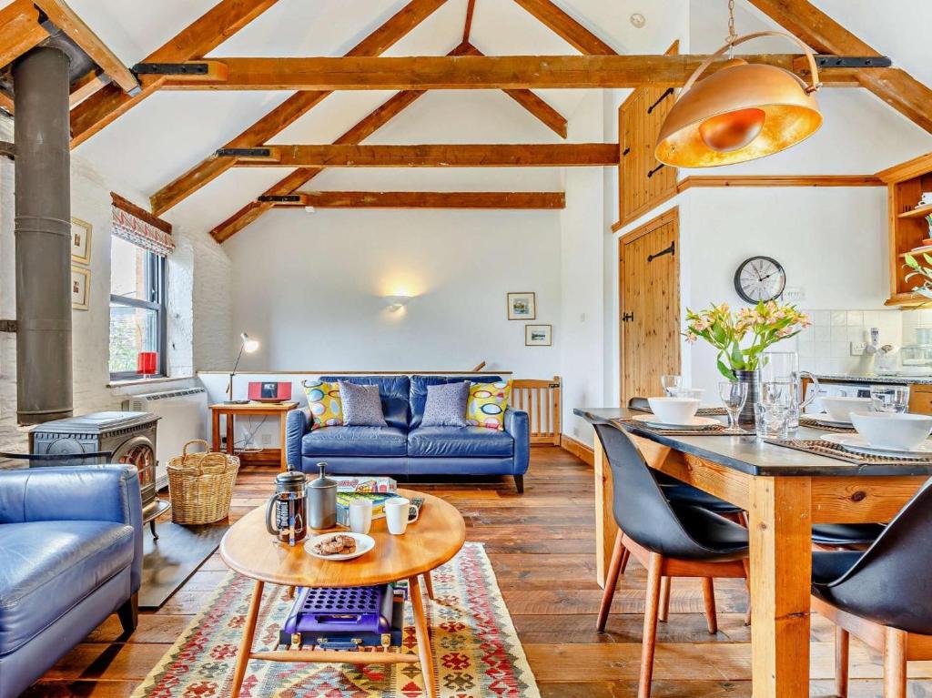 a living room with a blue couch and a table at 2 Bed in Fowey oc-55381 in Golant