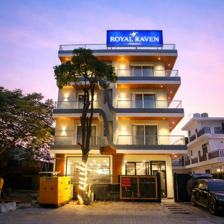 a building with a sign on top of it at Royal Raven Hotel & Banquet' Greater Noida Nearby India Expo Centre & Mart in Greater Noida