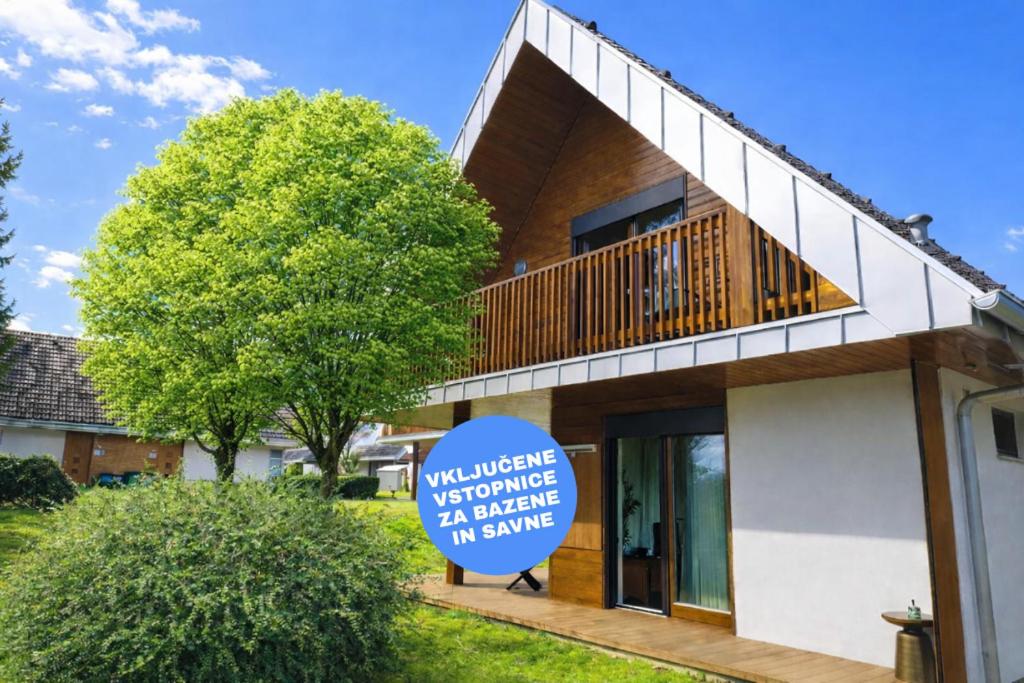 a house with a sign in front of it at Renovated Apartment ŽAJBELJ near Terme Topolšica in Topolšica