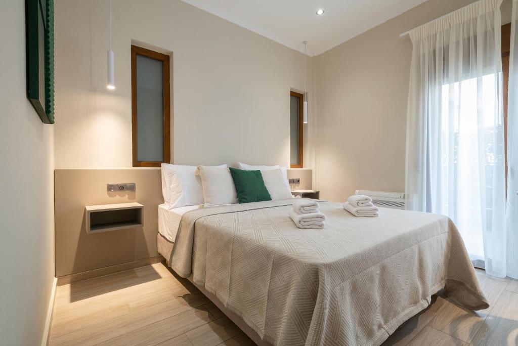 a bedroom with a bed with towels on it at Myrina Concept in Myrina