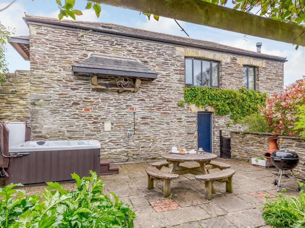 a patio with a picnic table and a building at 3 Bed in Fowey oc-55382 in Golant
