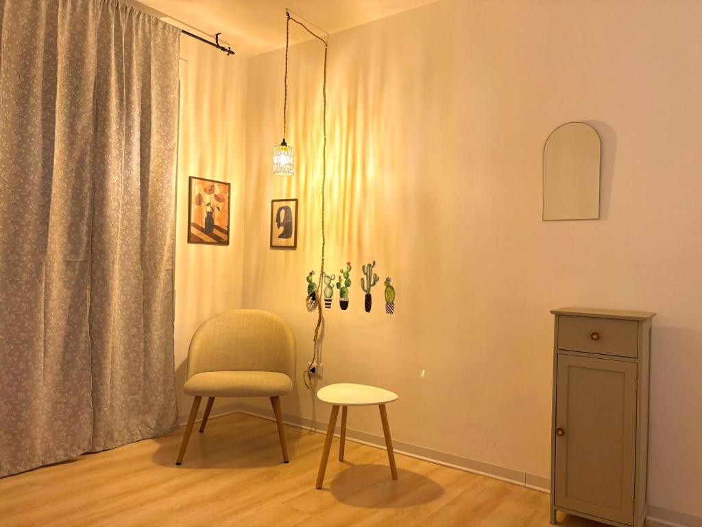 a living room with a chair and a table at Kalon Brion House in Lamezia Terme
