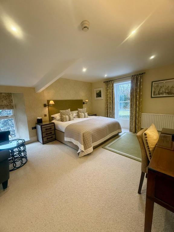 a large bedroom with a bed and a window at The Grasmere Hotel in Grasmere