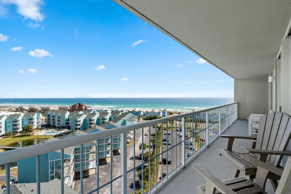 a balcony with chairs and a view of the ocean at Tristan Towers Unit 10E in Pensacola Beach