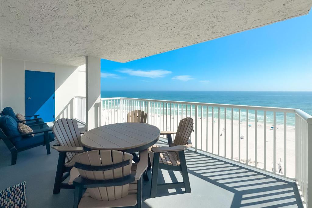 a balcony with a table and chairs and the ocean at Romar Tower Unit 9D in Orange Beach