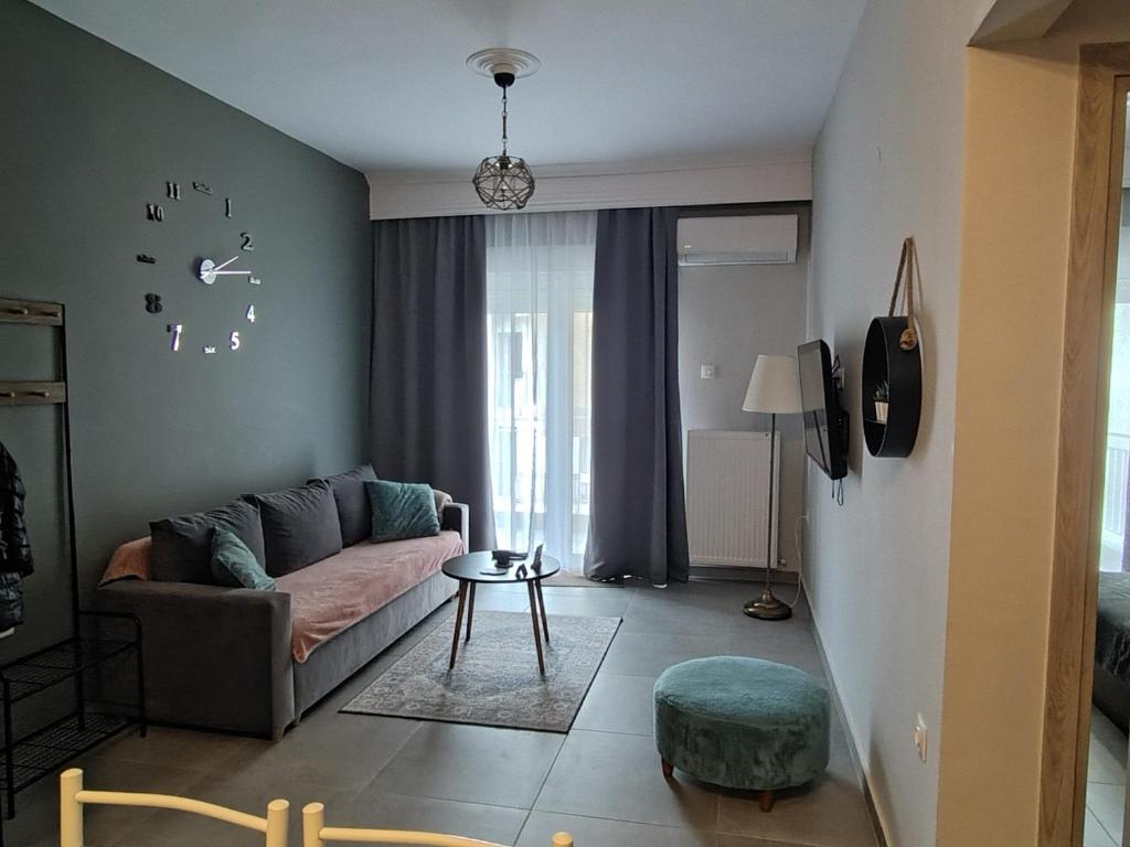 a living room with a couch and a table at Vasiliki's apartment in Serres