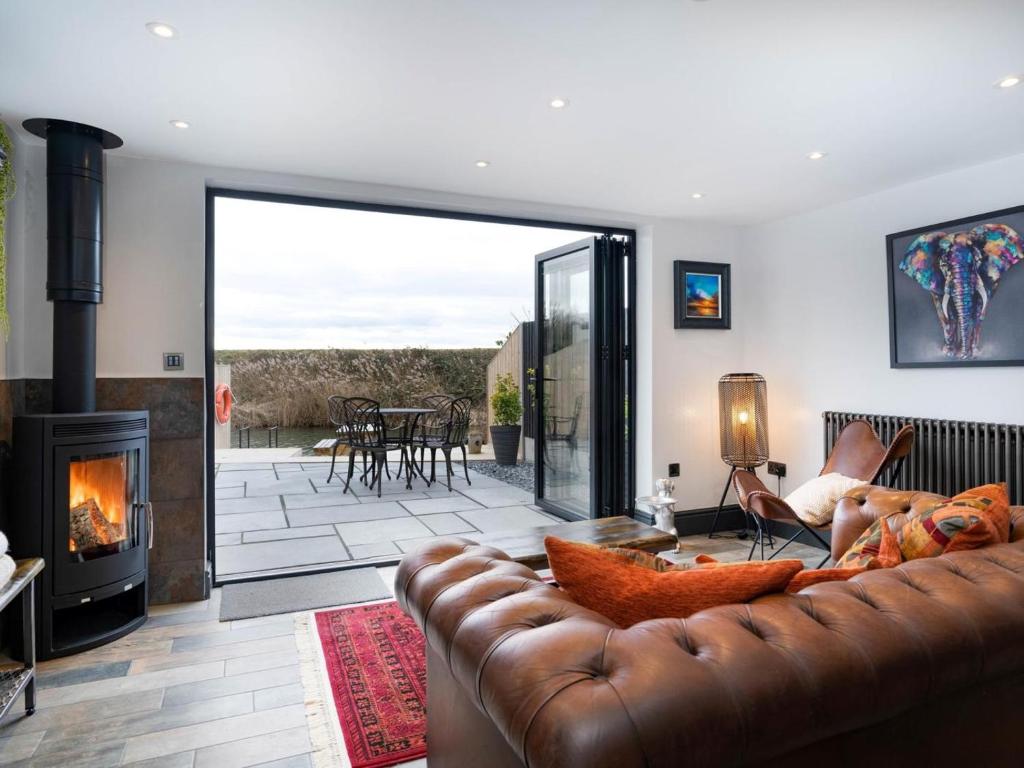 a living room with a couch and a fireplace at 2 Bed in Spalding oc-91528 in Surfleet