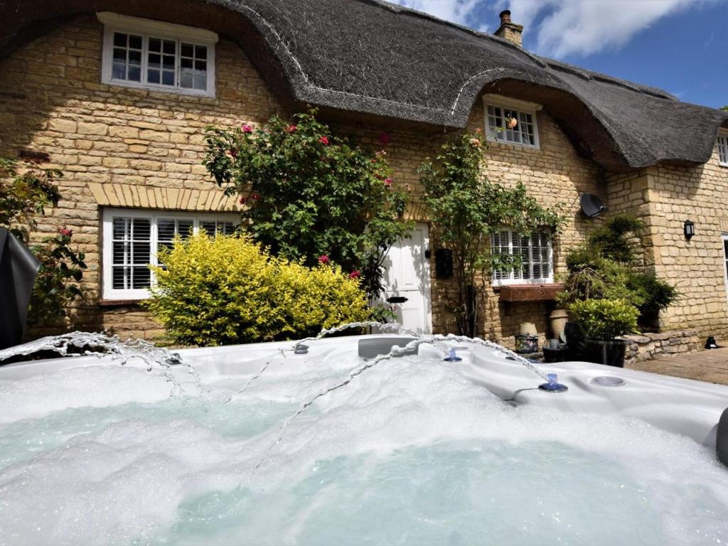 a house with a pile of snow in front of it at 4 Bed in Oakham oc-86556 in Empingham