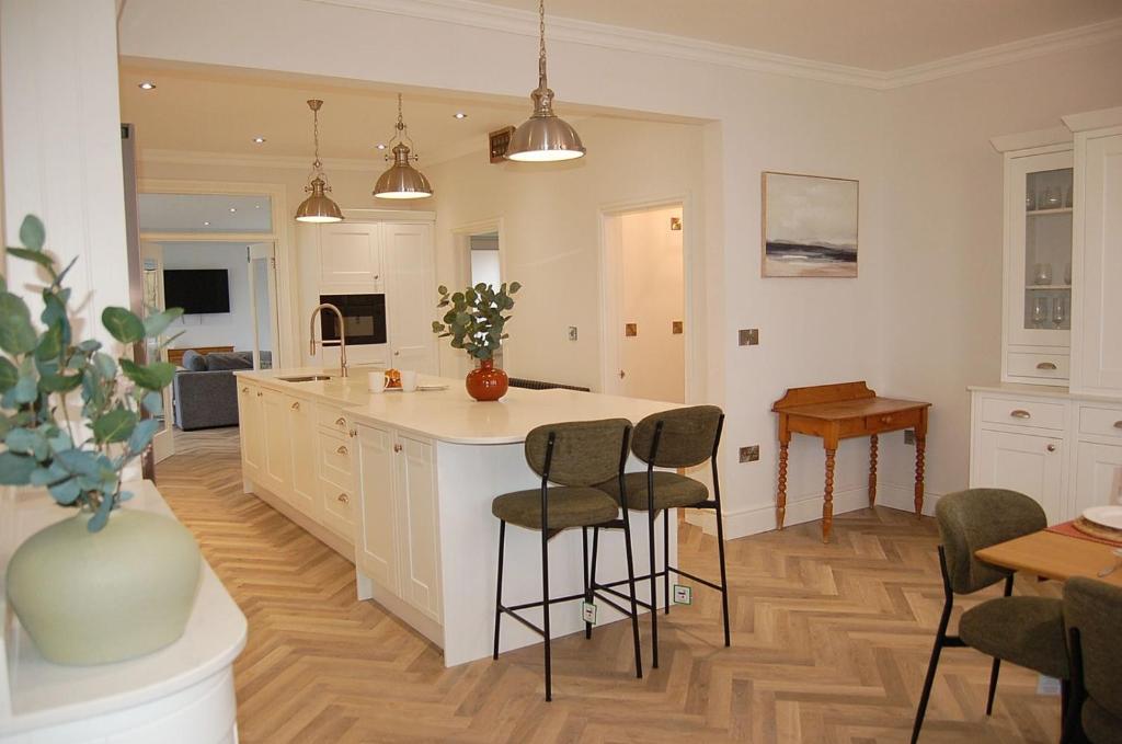 a kitchen with a island in the middle of a room at Morwendon House with Sea View in Llanaber