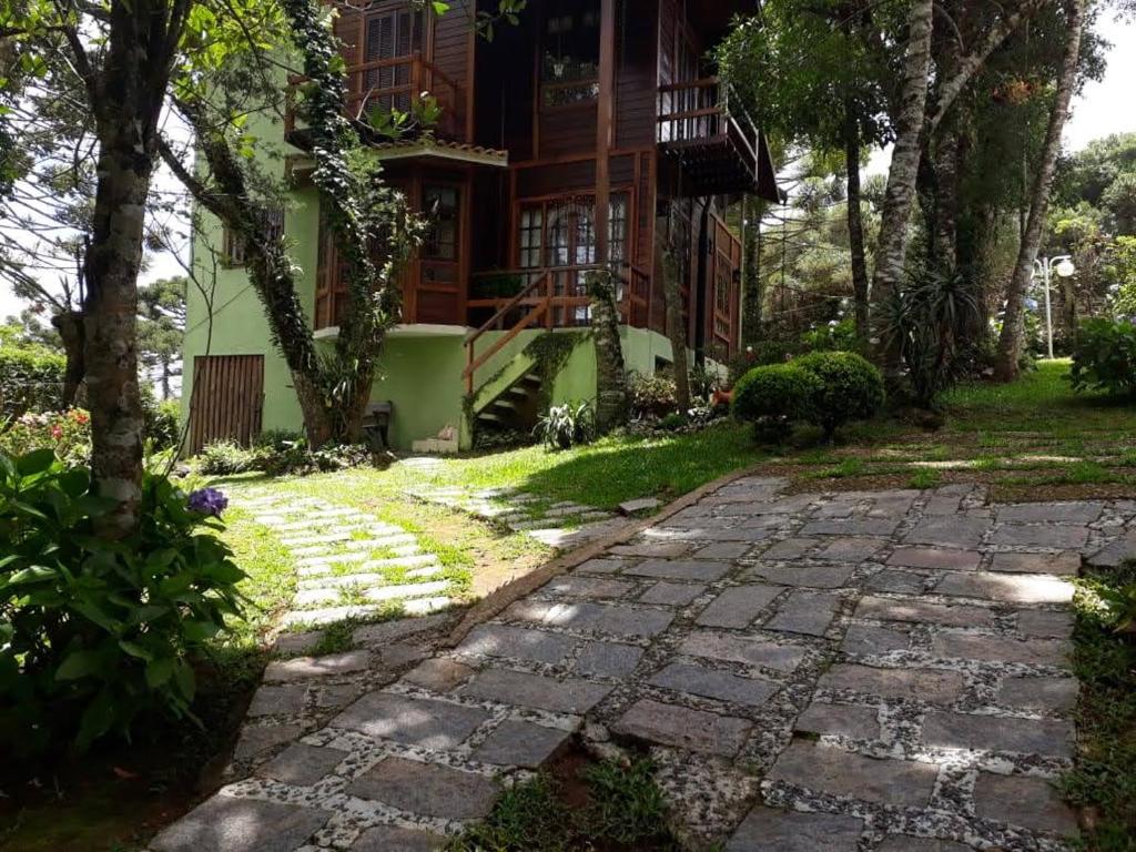 a stone path in front of a house at Casa de Campo em Monte Verde in Camanducaia