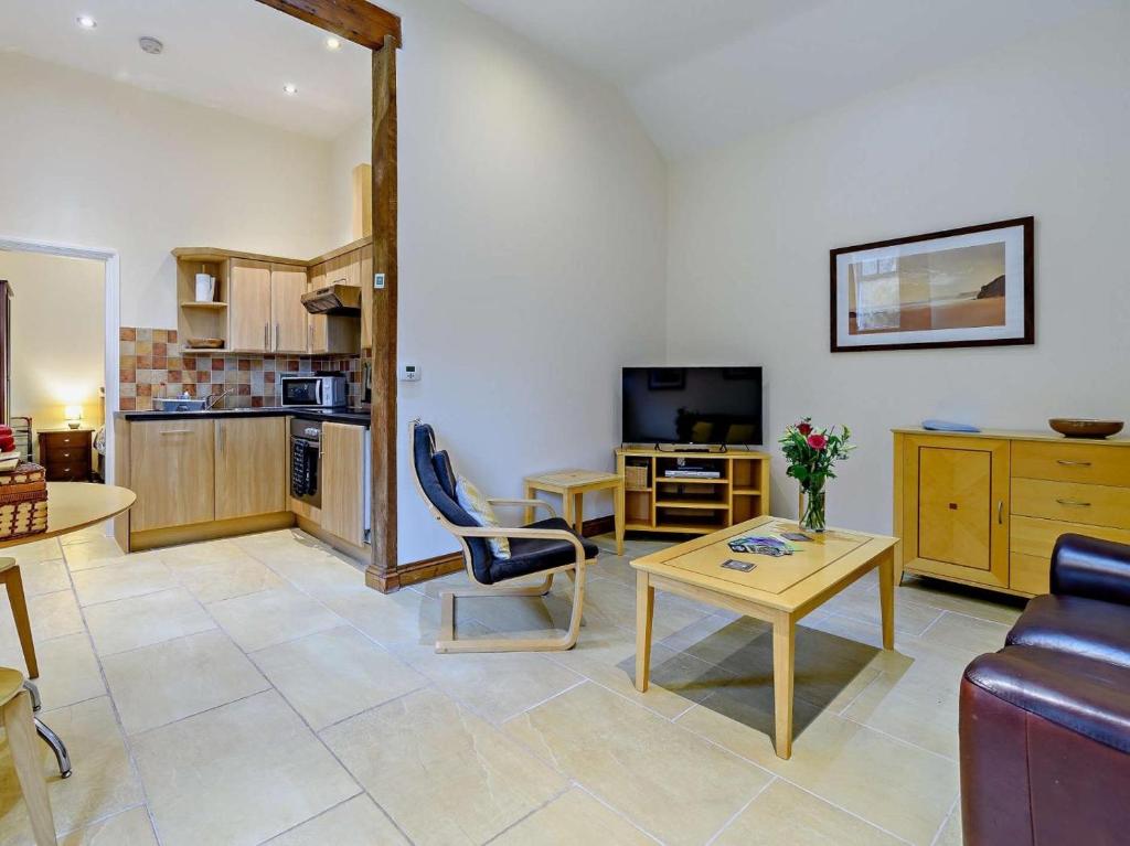 a living room with a couch and a table at 1 Bed in Doncaster oc-93768 in Mattersey