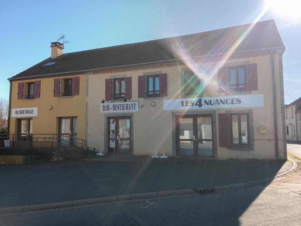 a building with a usaamines sign in front of it at Les 4 nuances in Youx