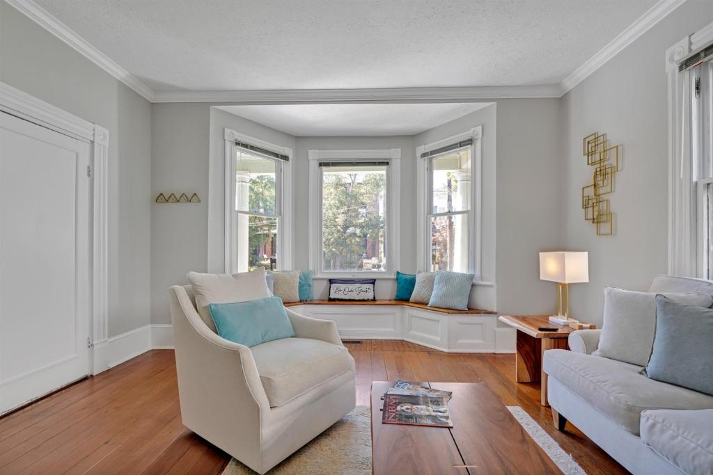 a living room with two chairs and a couch at Savannah Suite on Front in Wilmington