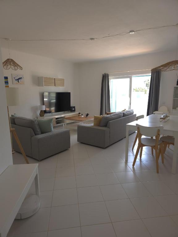 a living room with a couch and a table at Albur Beach House in Alvor