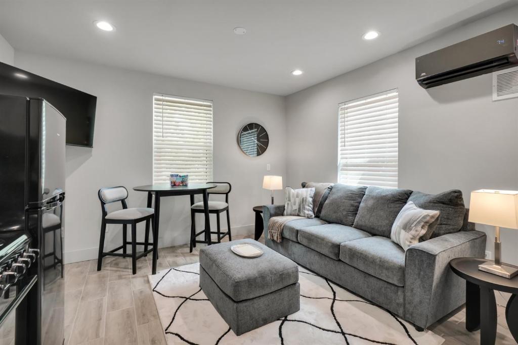 a living room with a couch and a table at The Pearl Stylish Couples Getaway in Wilmington