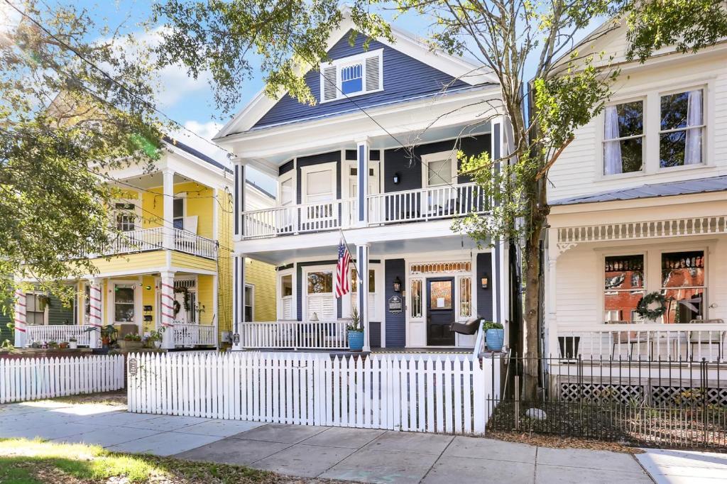 a white and yellow house with an american flag at The Simmons House on 5th Ave in Wilmington