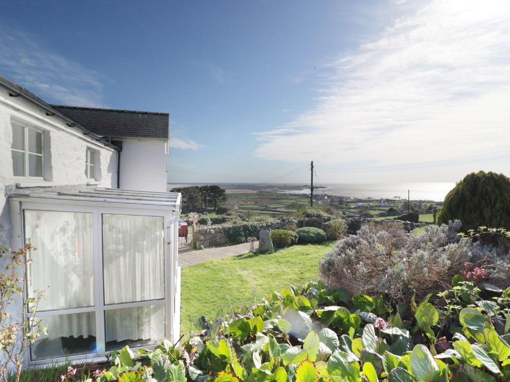 a garden in front of a house with a view at Happy Landing in Harlech