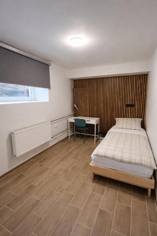 a bedroom with a bed and a desk and a table at Private Room in the Heart of Tallinn in Tallinn