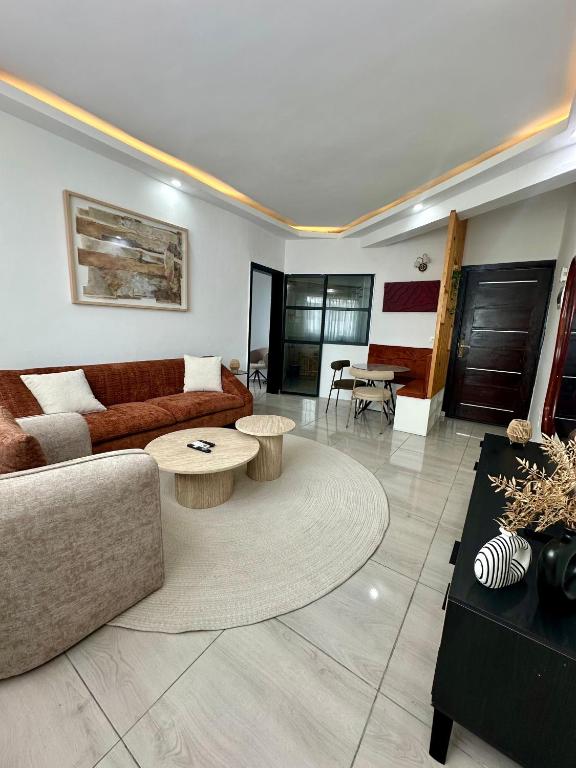a living room with a couch and a table at Nahé Résidence Deux Plateaux in Abidjan