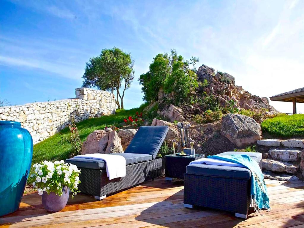 a patio with a couch and two ottoman at Villa Carla in Bonifacio