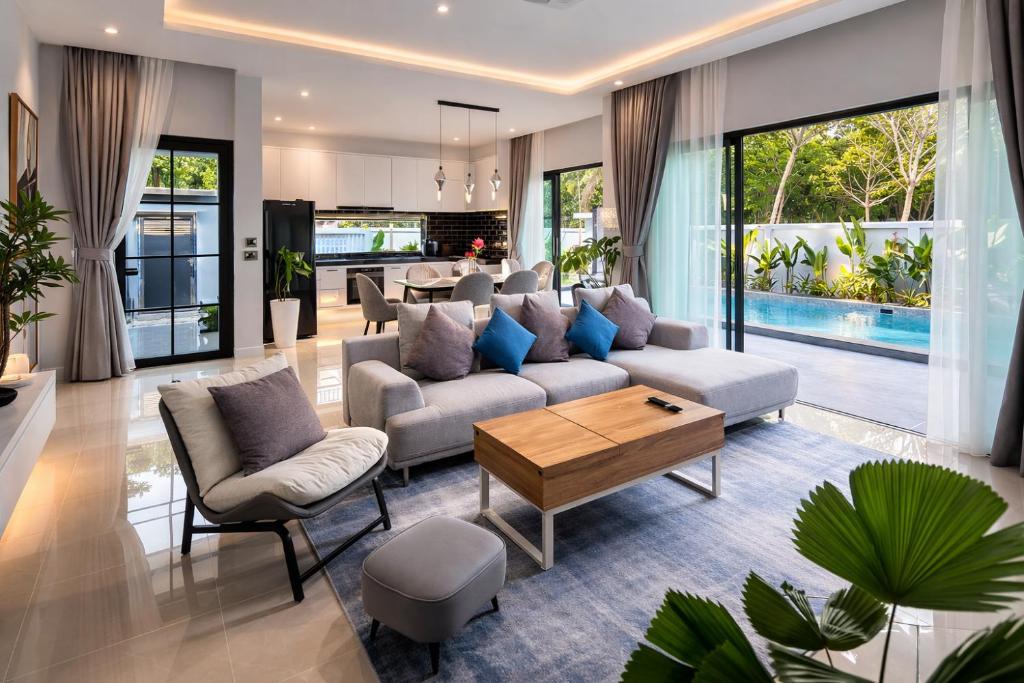 a living room with a couch and a table at Harmony Pool Villa Ao Nang in Ao Nang 