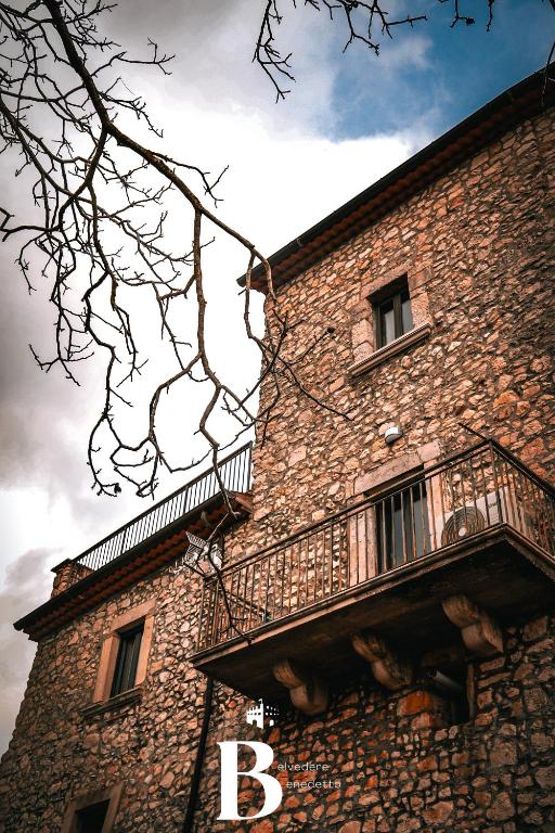 a large brick building with a balcony on the side at Belvedere Benedetto in Castelnuovo Parano