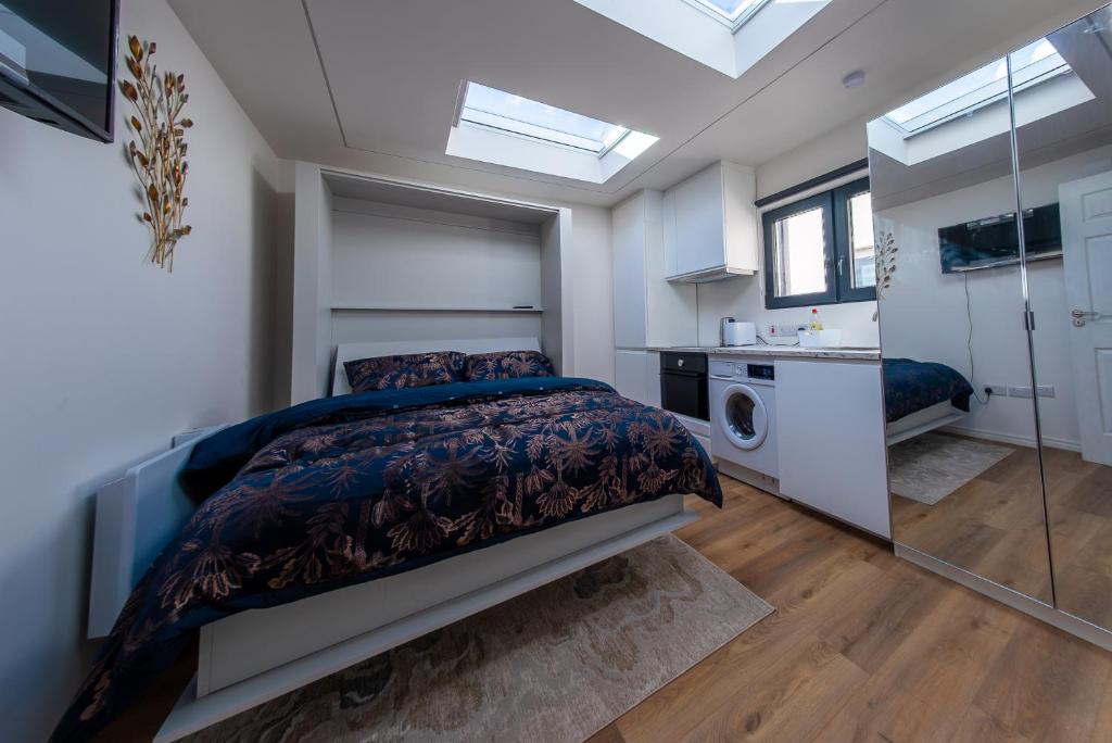 a bedroom with a bed and a bathroom with windows at Cozy Apartment in Dublin