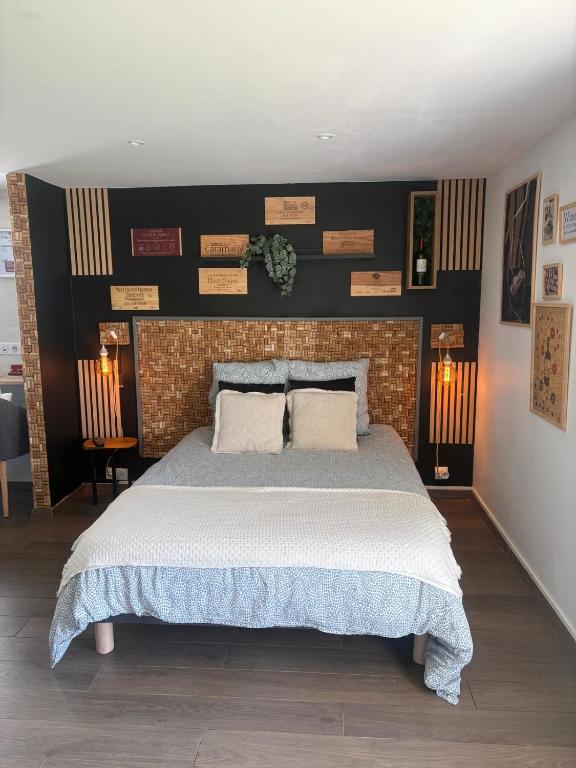 a bedroom with a large bed and a brick wall at Chambre d'Hôtes Arla Goxoki in Amendeuix-Oneix