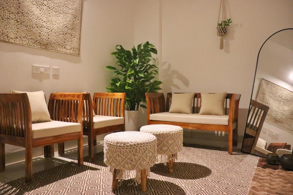 a room with chairs and tables and a plant at Gypsy Soul Gateaway - Casa Boho in Zirakpur