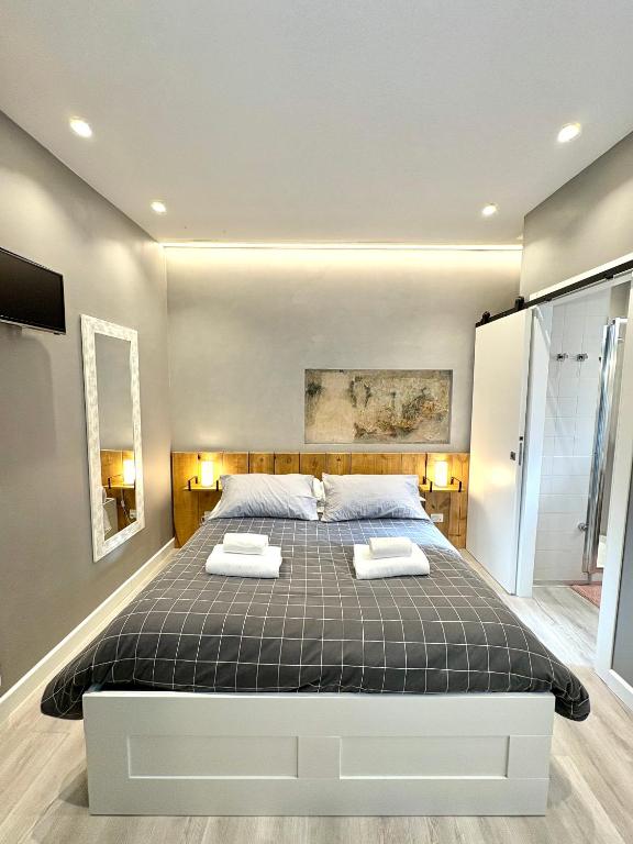 a bedroom with a bed with two towels on it at Cantore 20 - Le Arche Verona in Verona