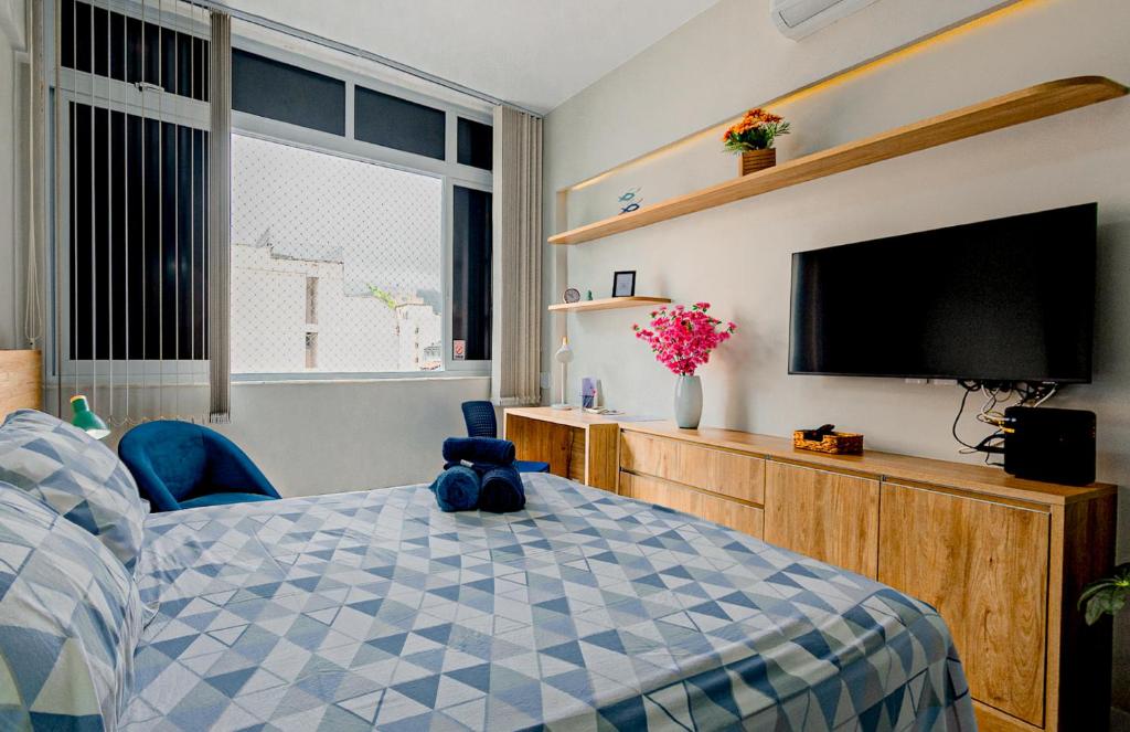 a bedroom with a teddy bear sitting on a bed at Charme da Santa Clara in Rio de Janeiro