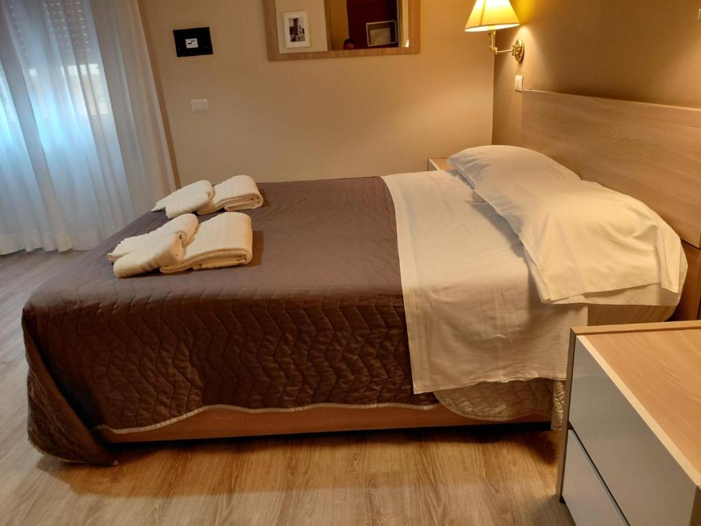 a bedroom with a bed with two towels on it at Piazza del Popolo Suites in Rome