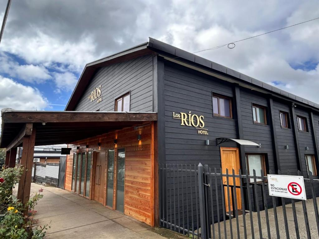 a black building with the raes written on it at Hotel Los Ríos in Panguipulli