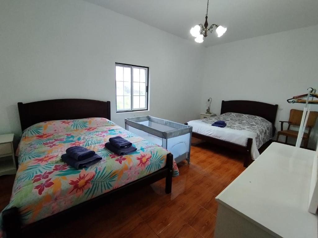 a bedroom with a bed and a dresser in it at Casa dos Fenais in Praia da Graciosa