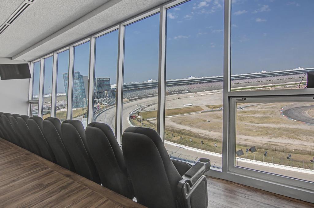 a conference room with chairs and a view of an airport at Shop & Dine: Fort Worth Condo w/ Racetrack Views! in Fort Worth