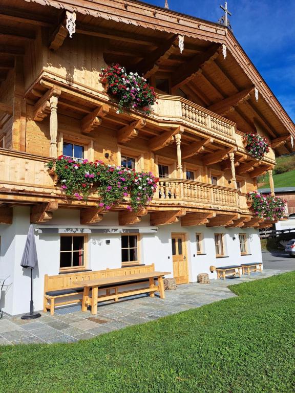 a building with a bench in front of it at Ferienwohnung Altrach in Aurach bei Kitzbuhel