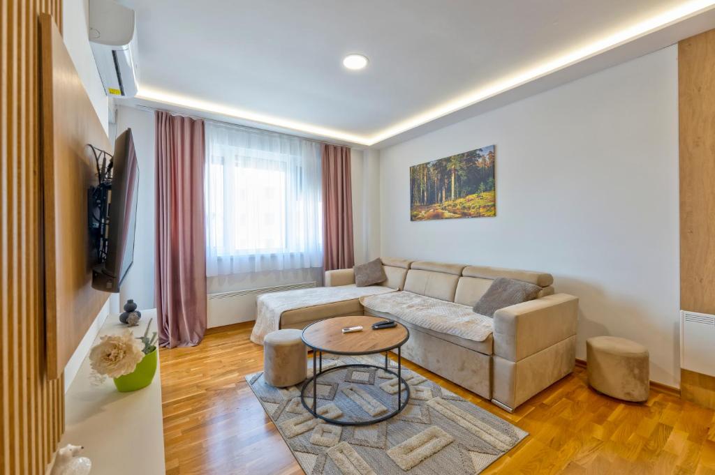 a living room with a couch and a table at Vip Bogic 108 in Zlatibor