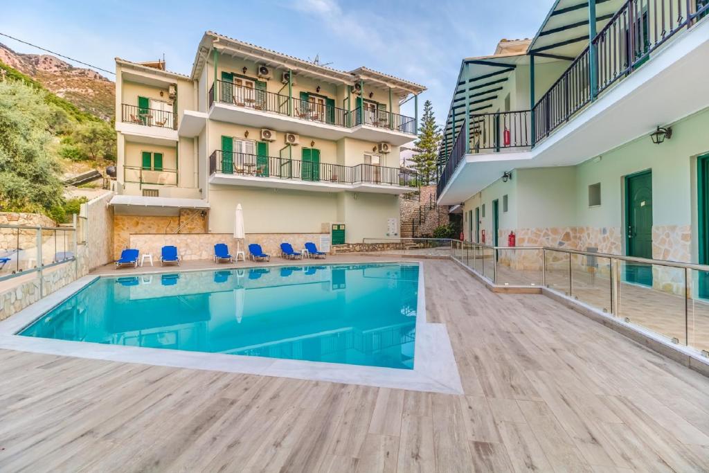 a swimming pool in the courtyard of a building at Vergina Star Hotel in Nikiana