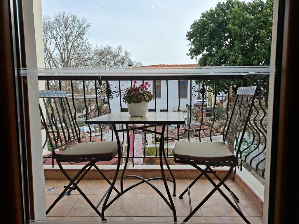 a table and two chairs on a balcony at Paradise Bridge in Xanthi