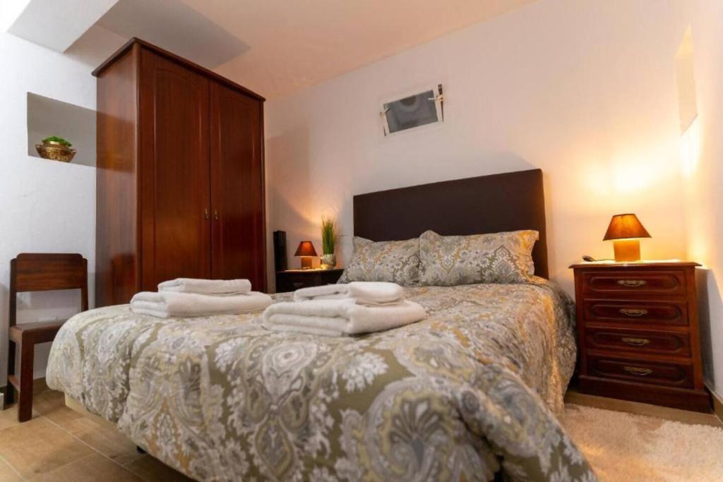 a bedroom with a bed with towels on it at Casa Fernandes by Mth in Ribeira Brava